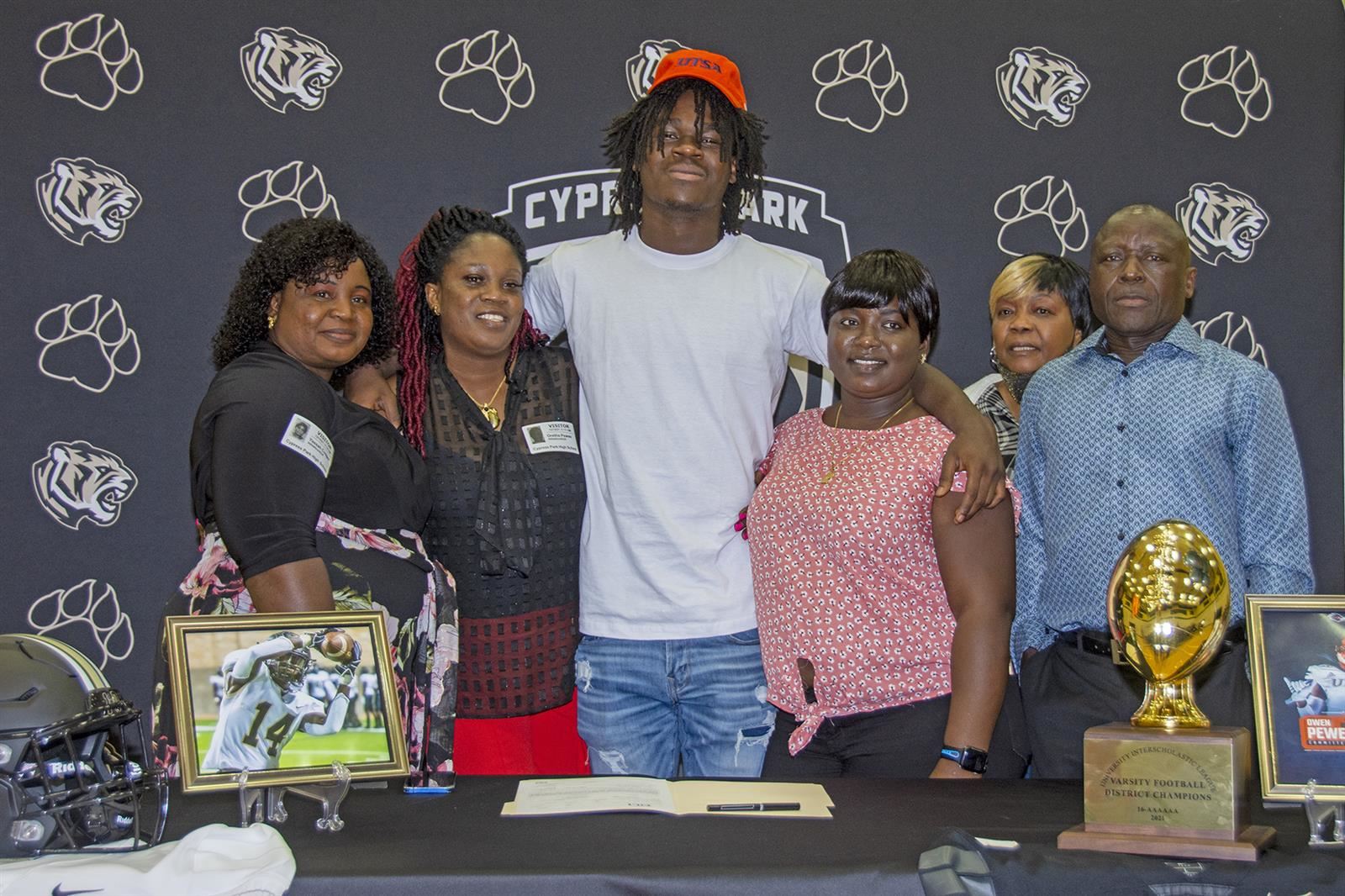 Cypress Park High School senior Owen Pewee, center, poses with his family after signing his letter of intent.